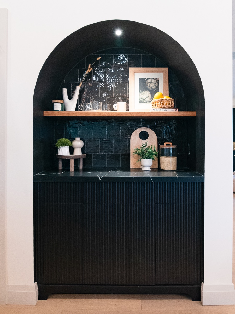 An arched reading nook finished in warm plaster, an example of the finish standard planned for Dawn & Dusk