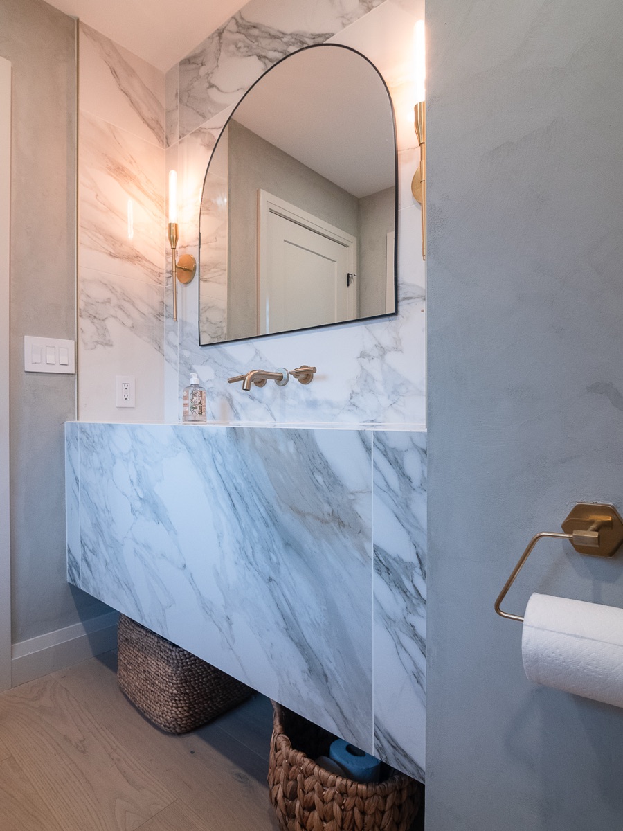 A marble powder room detail, an example of the finish standard planned for Dawn & Dusk